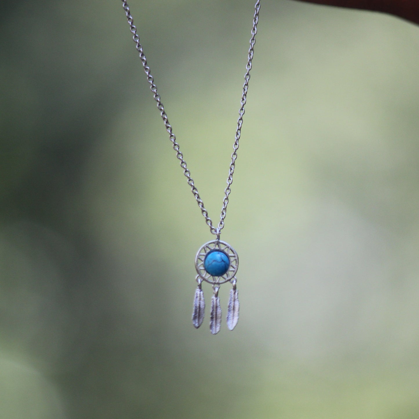 Silver dream catcher with turquoise gem